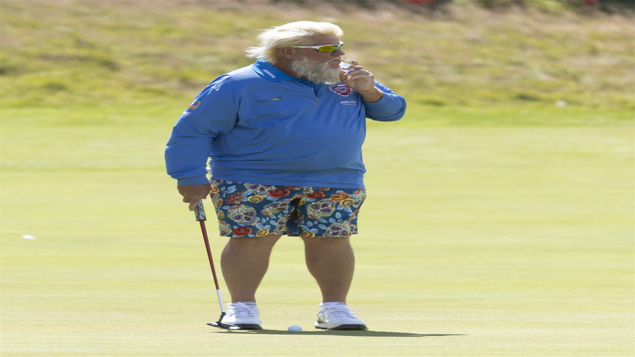 John Daly puffs cigarette while practicing for The Open after winning over fans with Past Champions Dinner suit