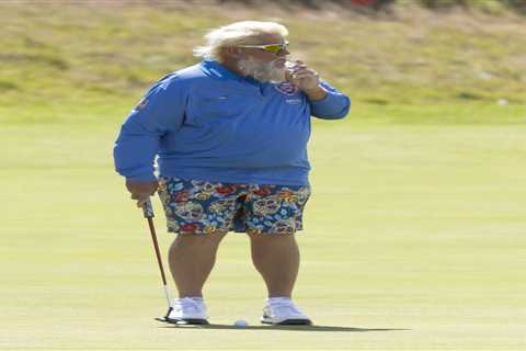 John Daly puffs cigarette while practicing for The Open after winning over fans with Past Champions ..