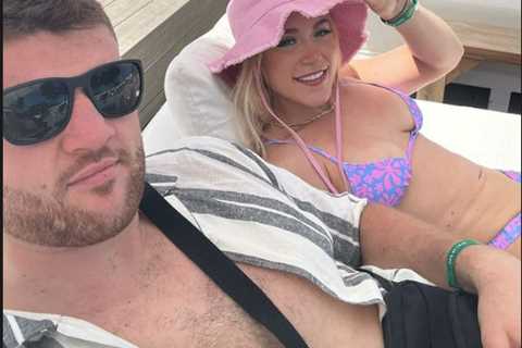 Elle Brooke relaxes in bikini in Magaluf then bursts into laughter as her huge boxer pal is..