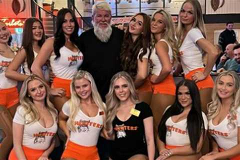 Former Open champion John Daly hangs out in Hooters with host of busty waitresses after missing the ..